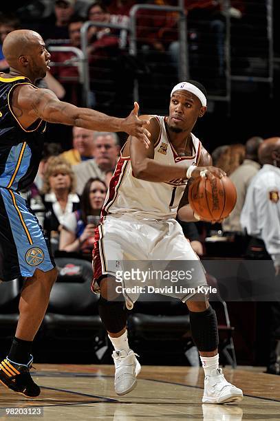 Daniel Gibson of the Cleveland Cavaliers passes the ball around Chauncey Billups of the Denver Nuggets during the game on February 18, 2010 at...