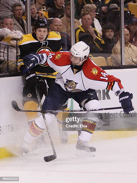 Radek Dvorak of the Florida Panthers shoves Matt Hunwick of the Boston Bruins into the boards on April 1, 2010 at the TD Garden in Boston,...