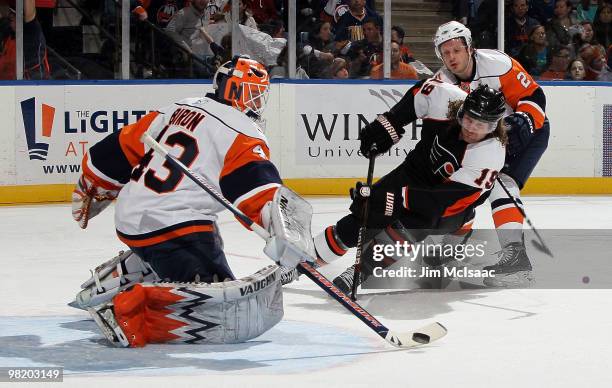 Martin Biron and Mark Streit of the New York Islanders stop a first period scoring chance from Scott Hartnell of the Philadelphia Flyers on April 1,...