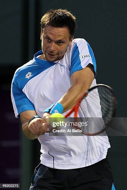 Robin Soderling of Switzerland returns a shot against Mikhail Youzhny of Russia during day ten of the 2010 Sony Ericsson Open at Crandon Park Tennis...