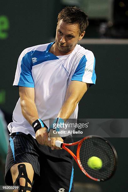 Robin Soderling of Switzerland returns a shot against Mikhail Youzhny of Russia during day ten of the 2010 Sony Ericsson Open at Crandon Park Tennis...