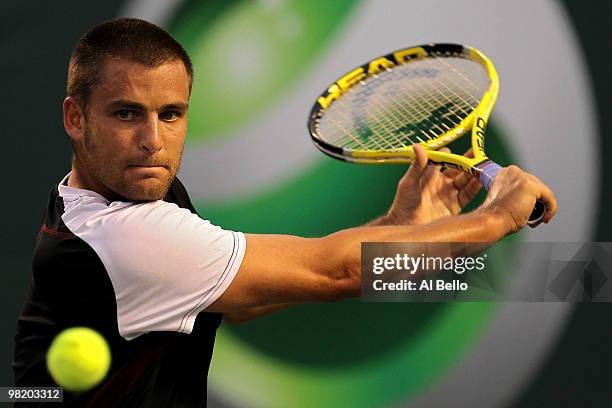 Mikhail Youzhny of Russia returns a shot against Robin Soderling of Switzerland during day ten of the 2010 Sony Ericsson Open at Crandon Park Tennis...