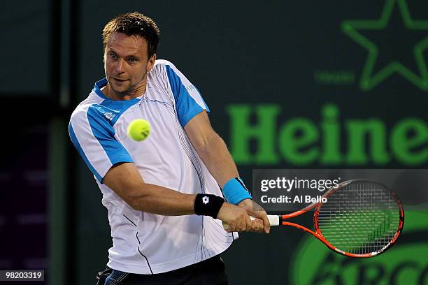 Robin Soderling of Switzerland returns a shot against Mikhail Youzhny of Russia during day ten of the 2010 Sony Ericsson Open at Crandon Park Tennis...