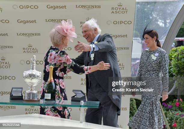 Dame Helen Mirren DBE and Sir Evelyn De Rothschild greet each other on day 5 of Royal Ascot at Ascot Racecourse on June 23, 2018 in Ascot, England.