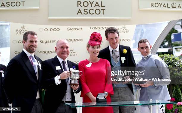 Peter Phillips and Autumn Phillips present owner Steve Parkin with a trophy and trainer Archie Watson and jockey Daniel Tudhope with a medal after...