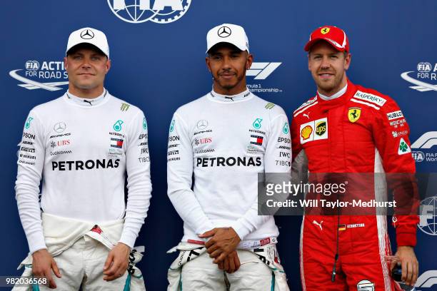 Top three qualifiers Lewis Hamilton of Great Britain and Mercedes GP, Valtteri Bottas of Finland and Mercedes GP and Sebastian Vettel of Germany and...