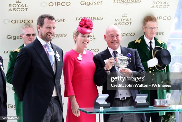 Peter Phillips and Autumn Phillips present owner Steve Parkin with a trophy after Soldier's Call wins the Windsor Castle Stakes during day five of...