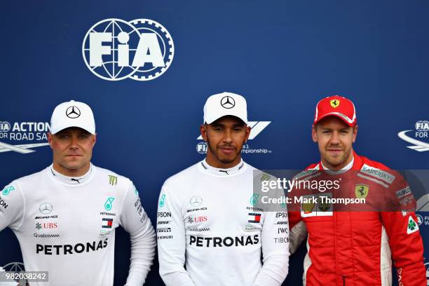 Top three qualifiers Lewis Hamilton of Great Britain and Mercedes GP, Valtteri Bottas of Finland and Mercedes GP and Sebastian Vettel of Germany and...