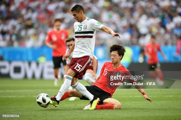 Hector Moreno of Mexico is tackled by Lee Jae-Sung of Korea Republic during the 2018 FIFA World Cup Russia group F match between Korea Republic and...