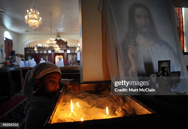 Helen Tesfay stares at lit candles at the Ethiopian Orthodox Church April 1, 2010 in Denver, Colorado. Members of the Ethiopian Orthodox Church...