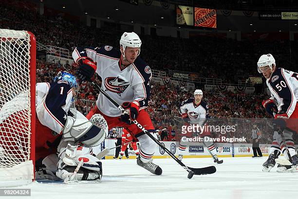 Marc Methot of the Columbus Blue Jackets protects the net along with teammate Steve Mason and Antoine Vermette during an NHL game against the Detroit...