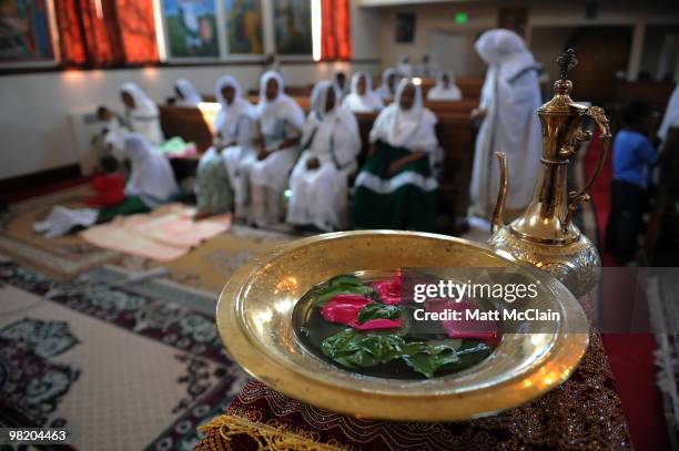 Golden bowl of water with flower petals sits on a table at the Ethiopian Orthodox Church April 1, 2010 in Denver, Colorado. Members of the Ethiopian...