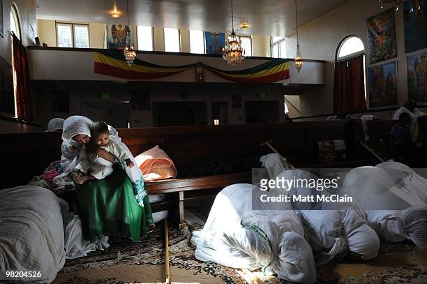 Tsega Haile holds her daughter, Tebereh Hadera, 8 months, at the Ethiopian Orthodox Church April 1, 2010 in Denver, Colorado. Members of the...