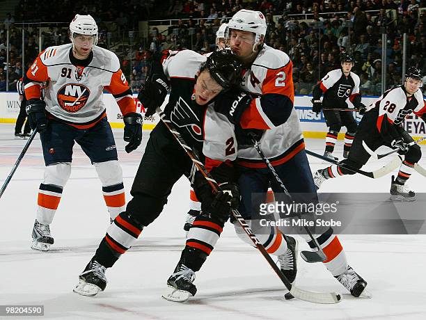 James van Riemsdyk of the Philadelphia Flyers gets roughed up by Mark Streit of the New York Islanders on April 1, 2010 at Nassau Coliseum in...