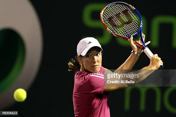 Justine Henin of Belgium returns a shot against Kim Clijsters of Belgium during day ten of the 2010 Sony Ericsson Open at Crandon Park Tennis Center...