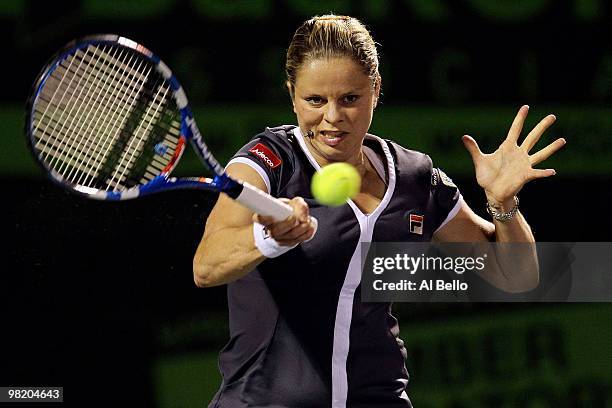 Kim Clijsters of Belgium returns a shot against Justine Henin of Belgium during day ten of the 2010 Sony Ericsson Open at Crandon Park Tennis Center...