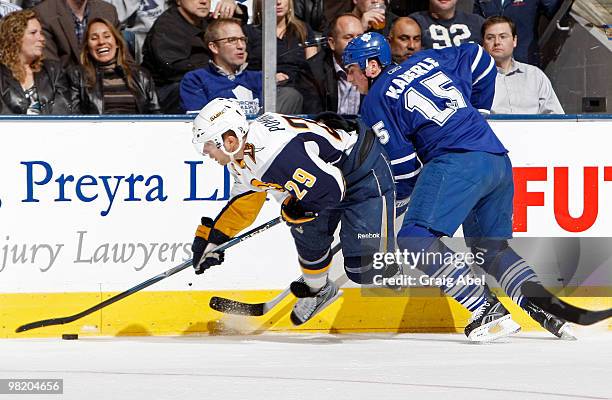 Tomas Kaberle of the Toronto Maple Leafs checks Jason Pominville of the Buffalo Sabres during game action April 1, 2010 at the Air Canada Centre in...