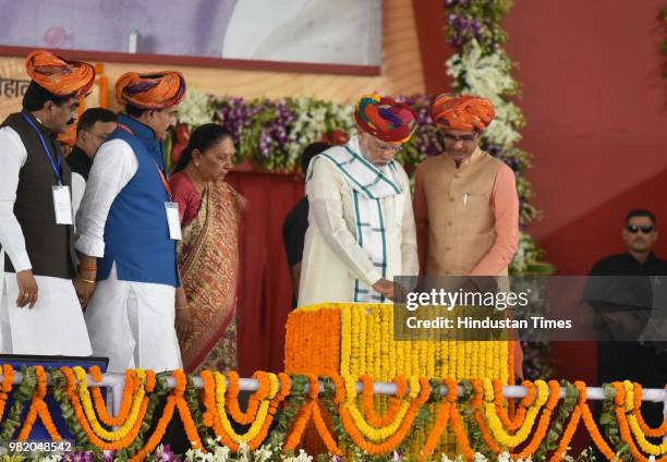 Prime Minister Narendra Modi along with Madhya Pradesh chief minister Shivraj Singh Chouhan inaugurates drinking water project as Governor Anandiben...