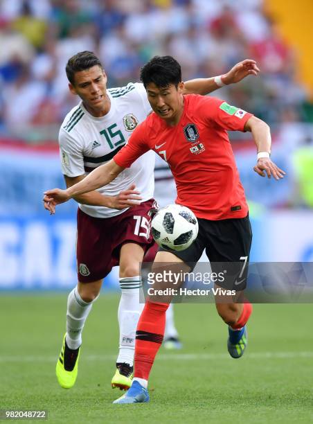 Heungmin Son of Korea Republic is challenged by Hector Moreno of Mexico during the 2018 FIFA World Cup Russia group F match between Korea Republic...