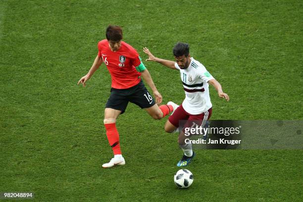 Ki Sung-Yueng of Korea Republic battles for possession with Carlos Vela of Mexico during the 2018 FIFA World Cup Russia group F match between Korea...