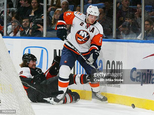 Scott Hartnell of the Philadelphia Flyers falls to the ice as Mark Streit of the New York Islanders goes after the puck on April 1, 2010 at Nassau...
