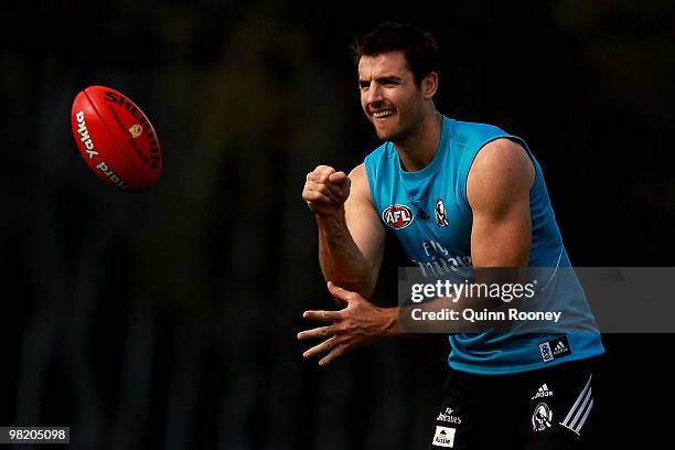 Darren Jolly of the Magpies handballs during a Collingwood Magpies training session at Gosch's Paddock on April 2, 2010 in Melbourne, Australia.