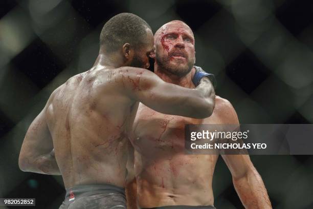 Mixed martial arts fighter Donald 'Cowboy' Cerrone of the US gets a hug from Leon 'Rocky' Edwards of Britain at the end of the fight during the UFC...
