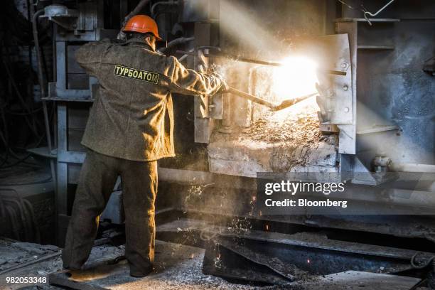 Worker stokes a furnace during steel manufacture at the Turboatom OJSC plant in Kharkiv, Ukraine, on Friday, June 22, 2018. Turboatom OJSC is a power...