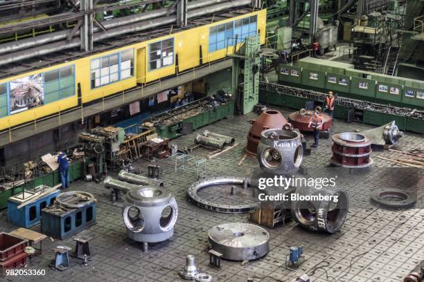Engineers work around turbine components on the factory floor during assembly at the Turboatom OJSC plant in Kharkiv, Ukraine, on Friday, June 22,...