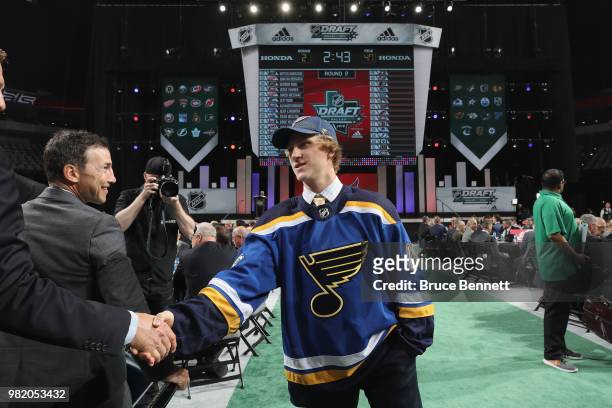 Scott Perunovich reacts after being selected 45th overall by the St. Louis Blues during the 2018 NHL Draft at American Airlines Center on June 23,...