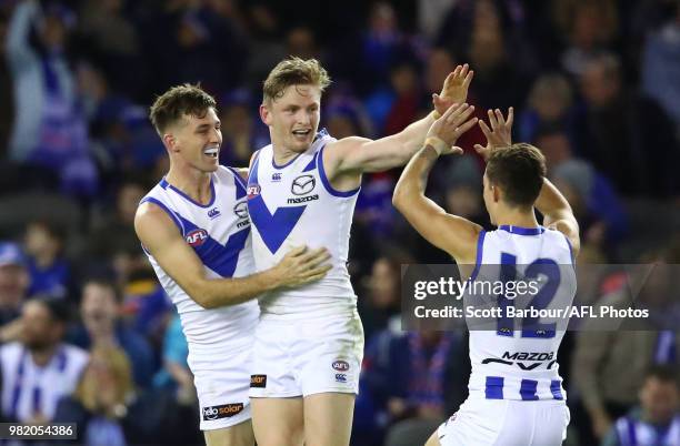 Jack Ziebell of the Kangaroos is congratulated by his teammates after kicking a goal during the round 14 AFL match between the Western Bulldogs and...