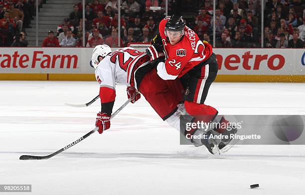 Anton Volchenkov of the Ottawa Senators blocks Erik Cole of the Carolina Hurricanes from breaking up ice to an empty net at Scotiabank Place on April...
