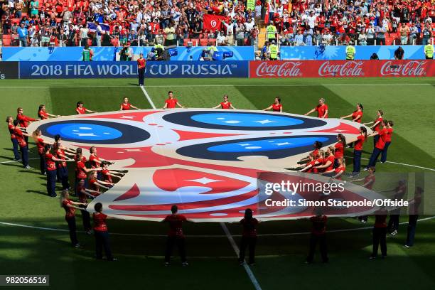 Volunteers display a huge banner of the tournament logo on the pitch prior to the 2018 FIFA World Cup Russia Group G match between Belgium and...