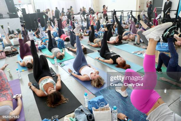 Guests do yoga at the Studio Tone It Up Live! at Duggal Greenhouse on June 23, 2018 in Brooklyn, New York.