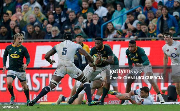 South Africa's flanker and captain Siya Kolisi attempts to avoid a tackle from England's lock Maro Itoje during the rugby union Test match between...