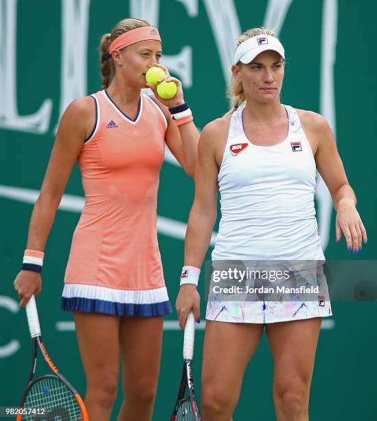 Kristina Mladenovic of France and Timea Babos of Hungary discuss tactics during their doubles semi-final match against Barbora Krejicova and Katerina...