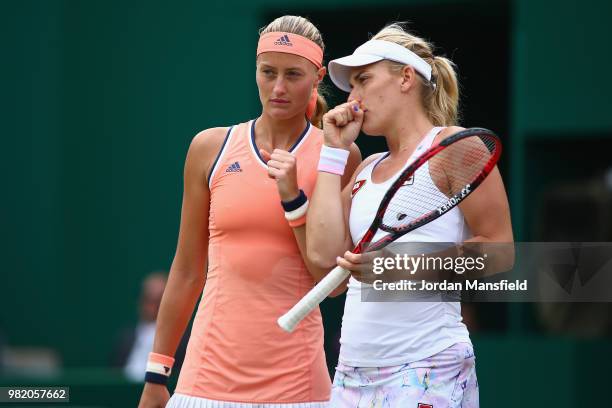 Kristina Mladenovic of France and Timea Babos of Hungary discuss tactics during their doubles semi-final match against Barbora Krejicova and Katerina...