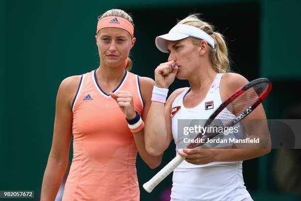 Kristina Mladenovic of France and Timea Babos of Hungary discuss tactics during their doubles semi-final match against Barbora Krejicova and Katerina...