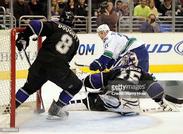 Mason Raymond of the Vancouver Canucks shoots over Jonathan Bernier of the Los Angeles Kings but has it stopped by Drew Doughty during the first...