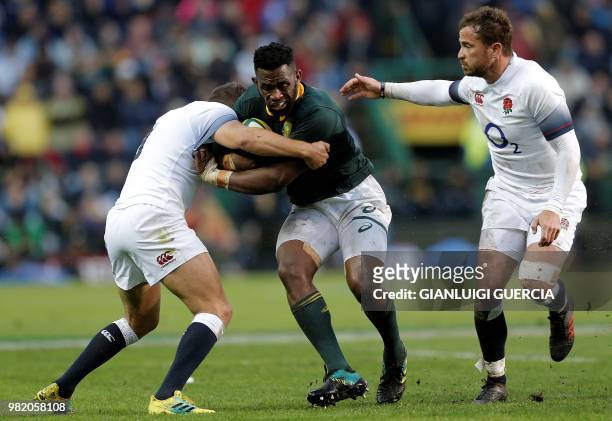 South Africa's flanker and captain Siya Kolisi is tackled during the rugby union Test match between South Africa and England at Newlands Rugby...