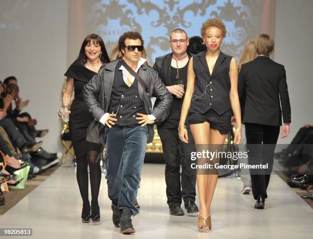 Jeanne Beker, Jie, Evan Biddell and a model walk the runway wearing Bustle fall 2010 collection at the Allstream Centre on April 1, 2010 in Toronto,...