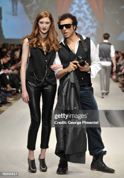 Jie and model walk the runway wearing Bustle fall 2010 collection at the Allstream Centre on April 1, 2010 in Toronto, Canada.