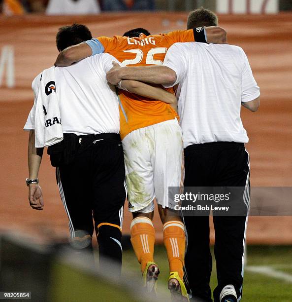 Brian Ching of the Housto Dynamo is assisted off the field by medical staff after injuring his left hamstring against Real Salt Lake on April 1, 2010...