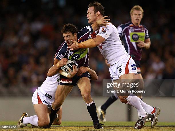 Billy Slater of the Storm is tackled during the round four NRL match between the Melbourne Storm and the St George Dragons at Olympic Park on April...