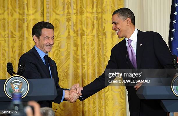 President Barack Obama shakes hands with French counterpart Nicolas Sarkozy during a joint press conference in the East Room of the White House in...