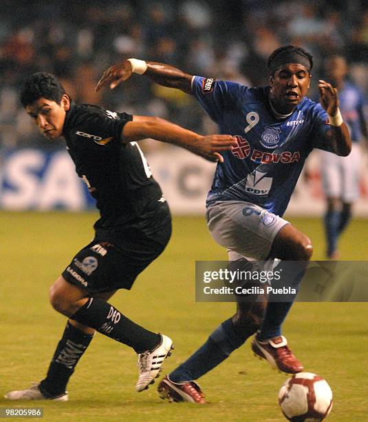 Silvano Estacio of Emelec vies for the ball with Luis Checa of Deportivo Quito during a 2010 Libertadores Cup match at the George Capwell Stadium on...