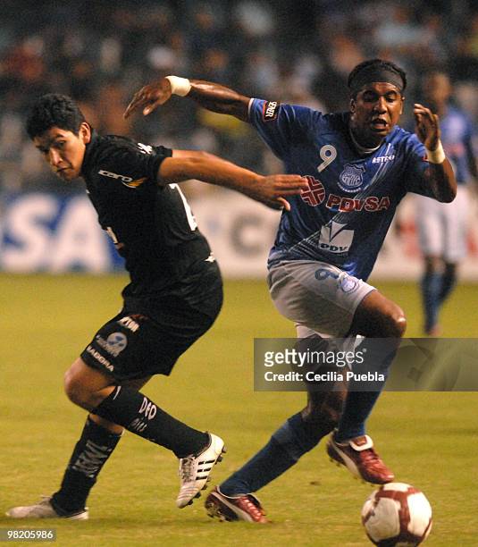 Silvano Estacio of Emelec vies for the ball with Luis Checa of Deportivo Quito during a 2010 Libertadores Cup match at the George Capwell Stadium on...