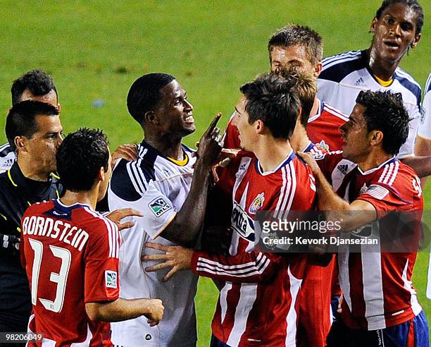 Edson Buddle of the Los Angeles Galaxy points a finger at Sacha Kljestan of Chivas USA as they argue during the first half of the MLS soccer match on...