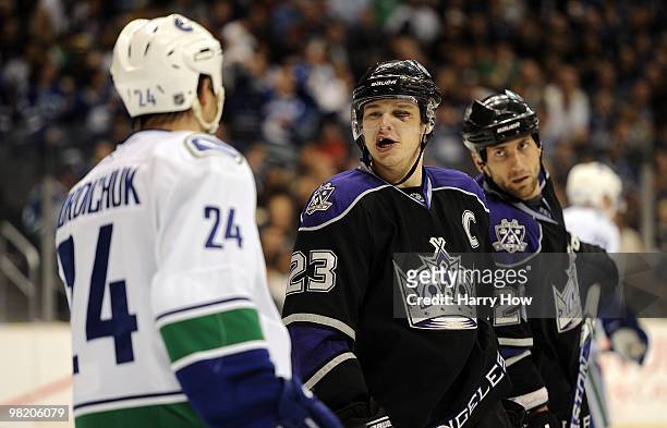 Dustin Brown and Jarret Stoll of the Los Angeles Kings exchange words with Darcy Hordichuk of the Vancouver Canucks during the second period at the...