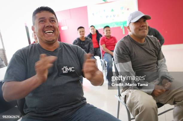 Migrants celebrate as Mexico scores on a penalty kick in the first half while watching the Mexico-South Korea World Cup match in the Salvation Army...